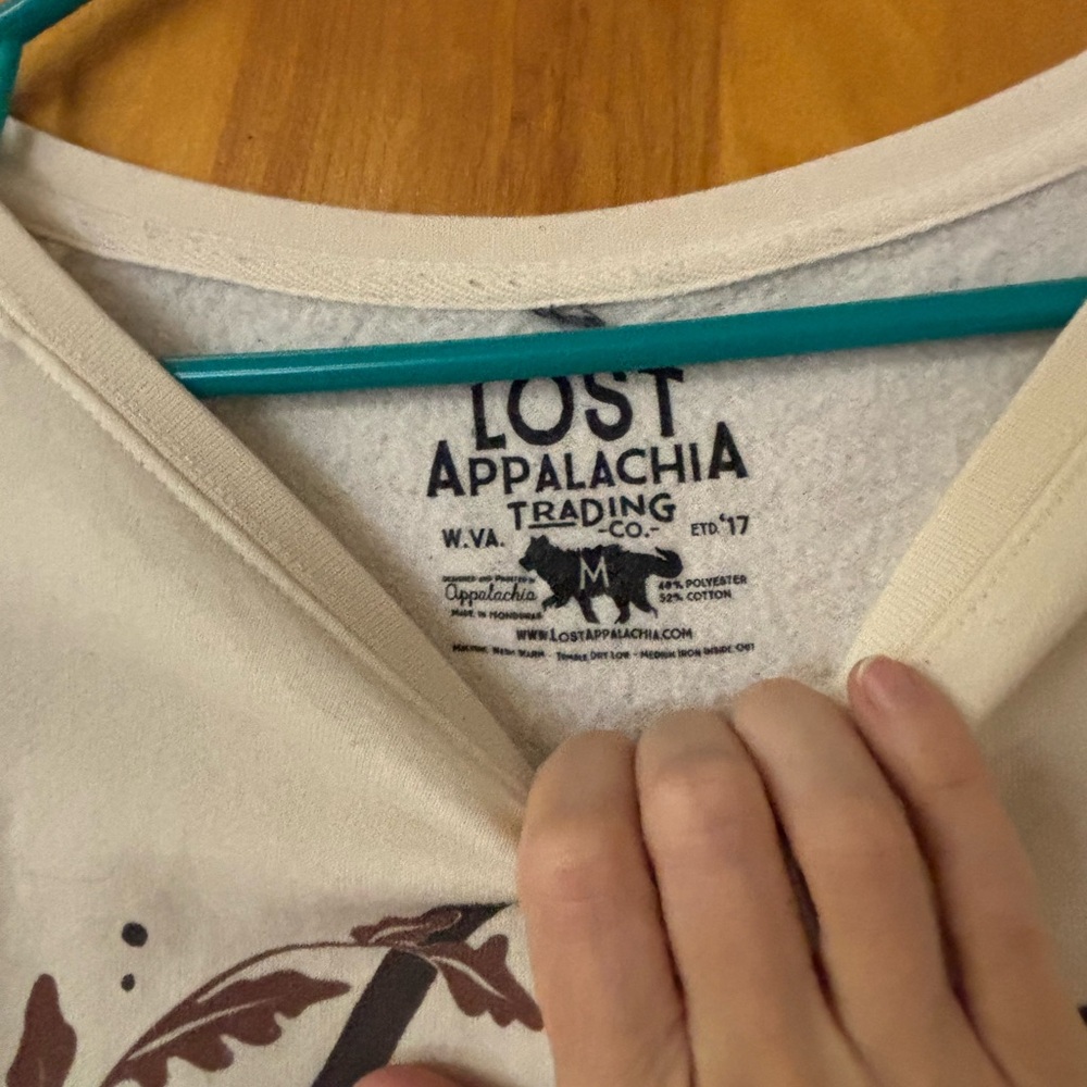 Cream colored lightweight sweatshirt.